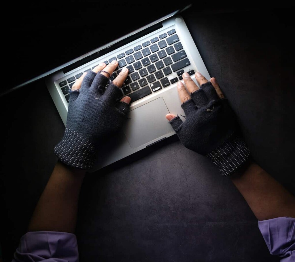 person in black long sleeve shirt using macbook pro