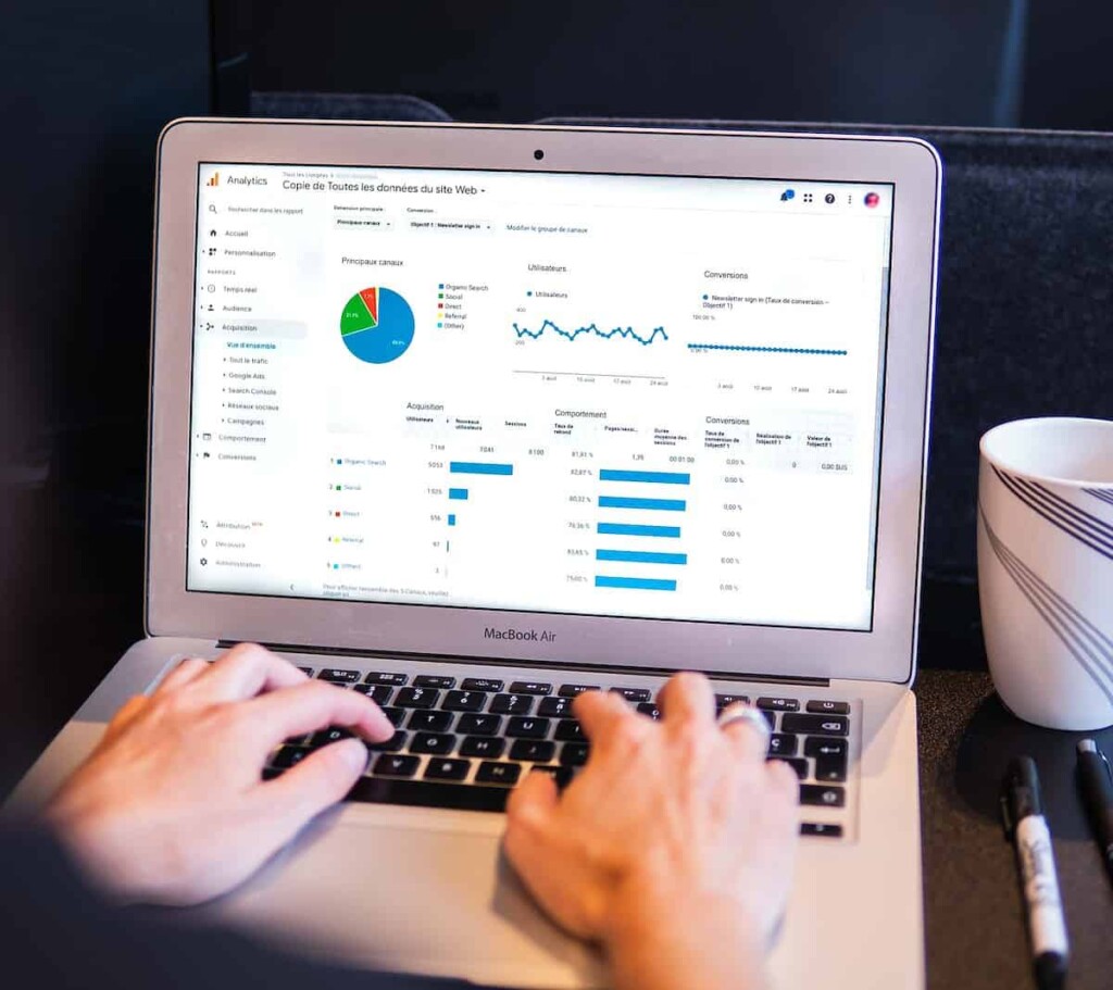 person using macbook pro on black table