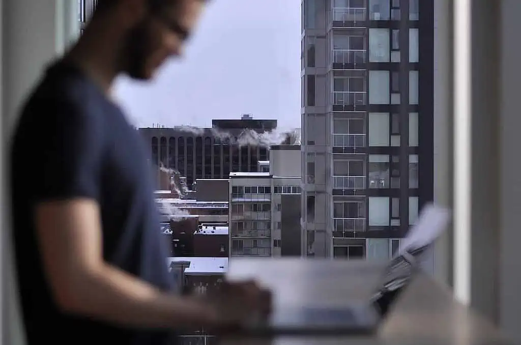 man standing while laptop computer