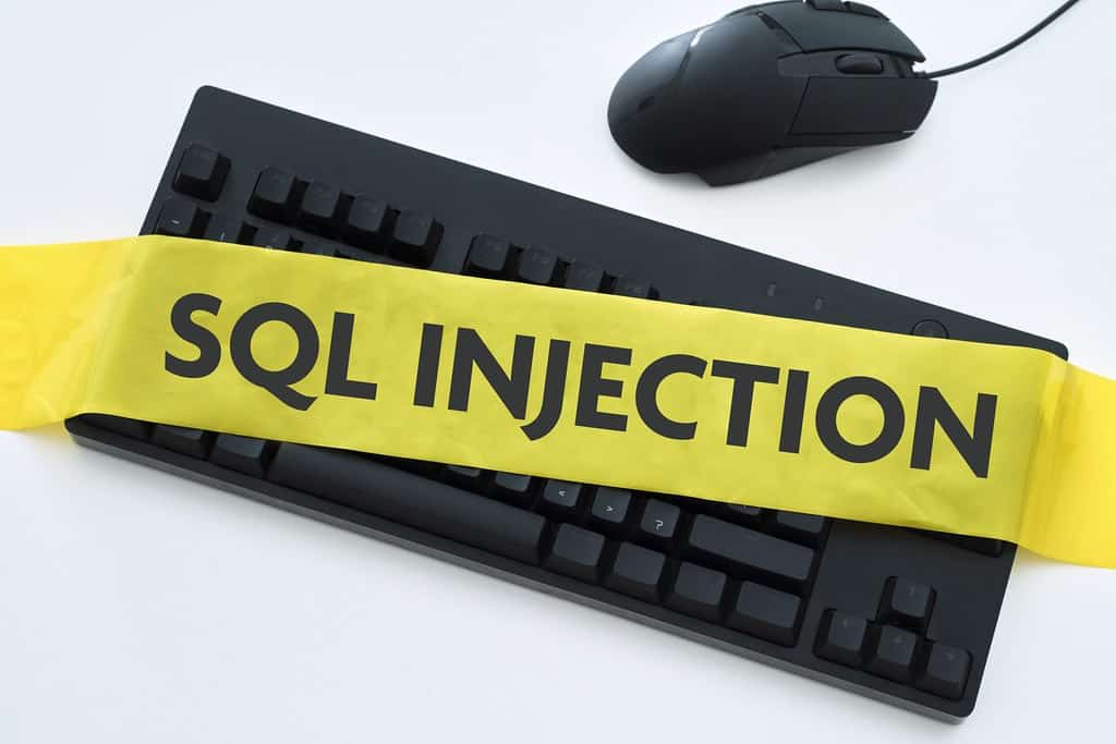 Big SQL Injection warning over a black keyboard